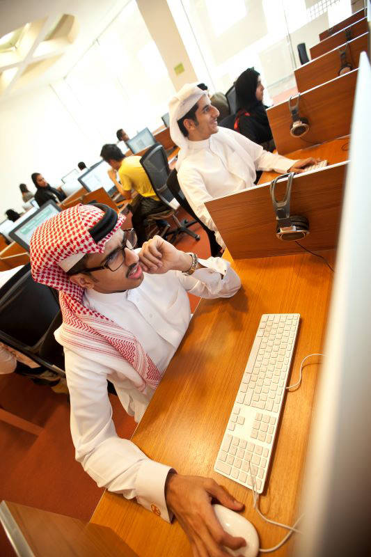 Students in front of computers at the GU-Q Library